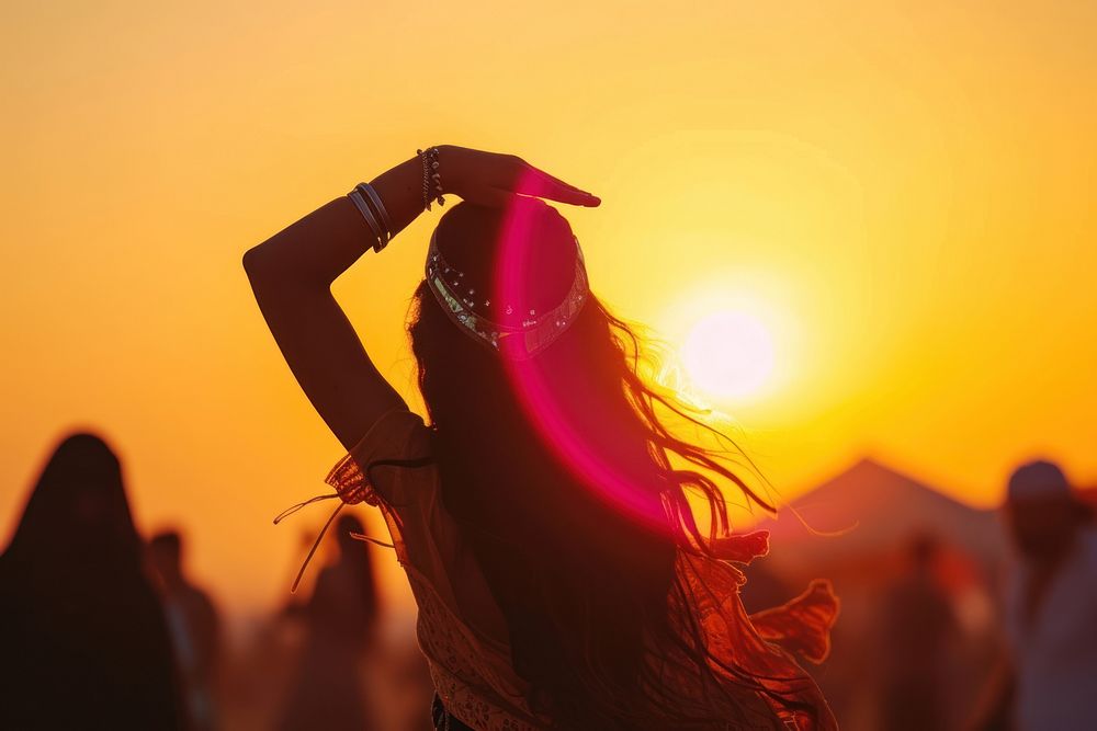 Middle Eastern girl dancing backlighting sunset summer.