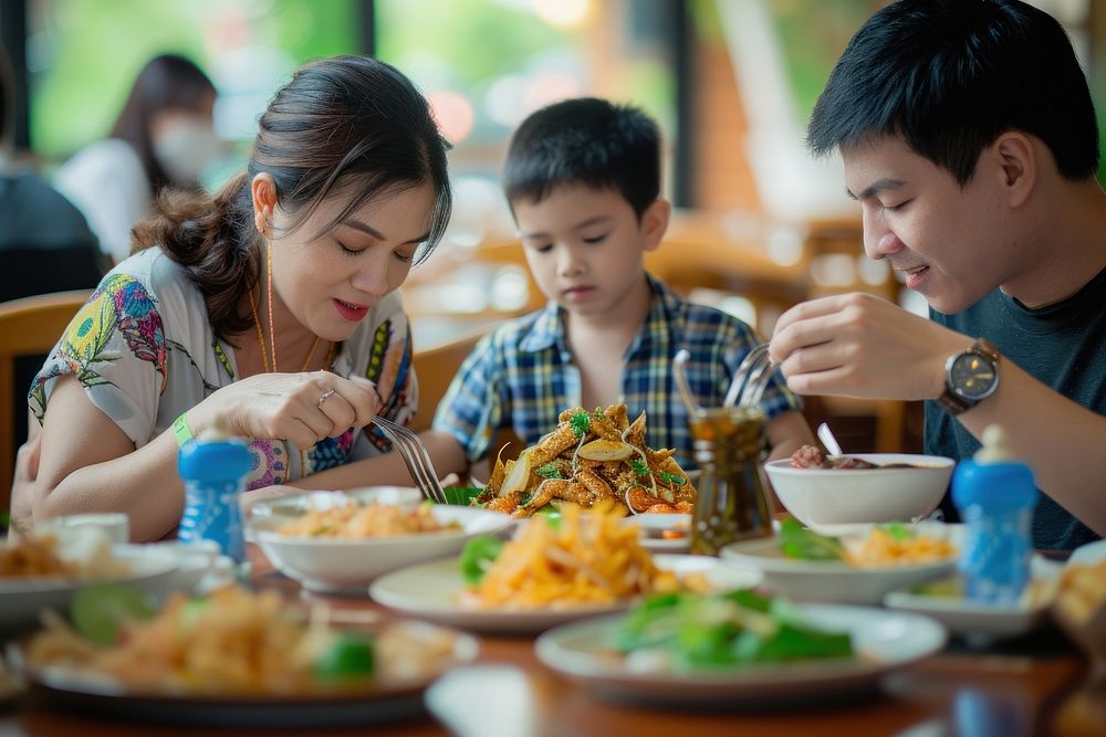 Thai family dinner som tum restaurant father eating.