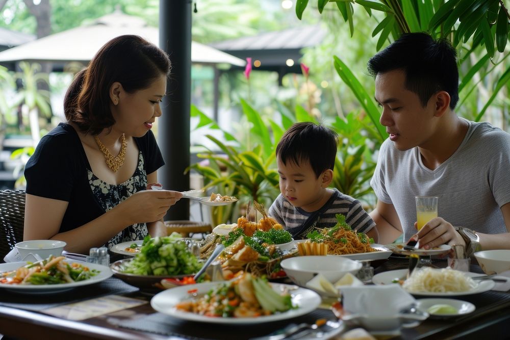 Thai family dinner som tum restaurant father eating.