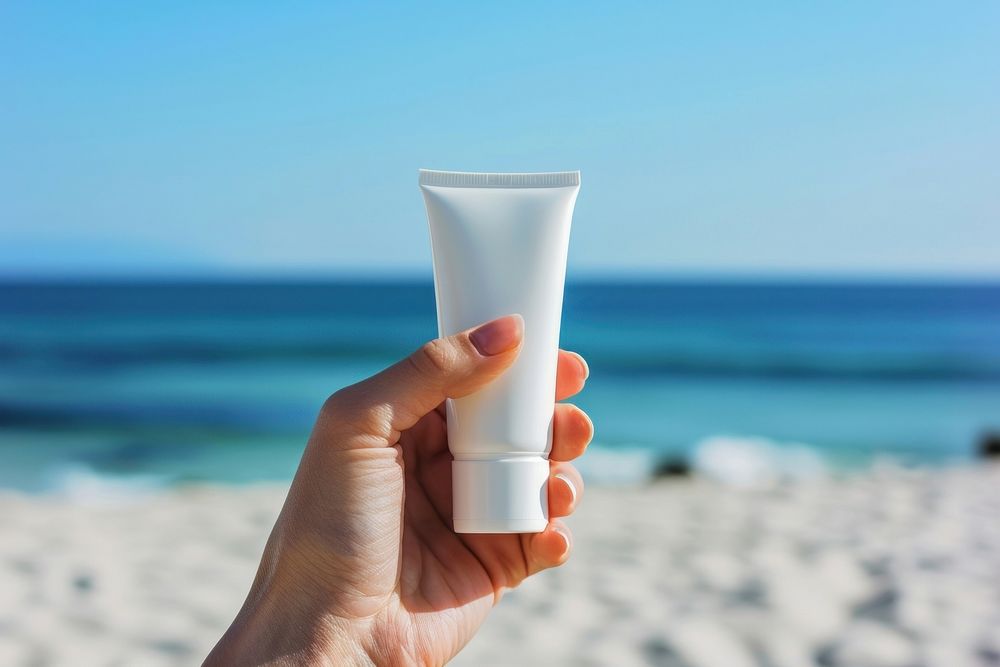 Cream tube cosmetics holding beach.