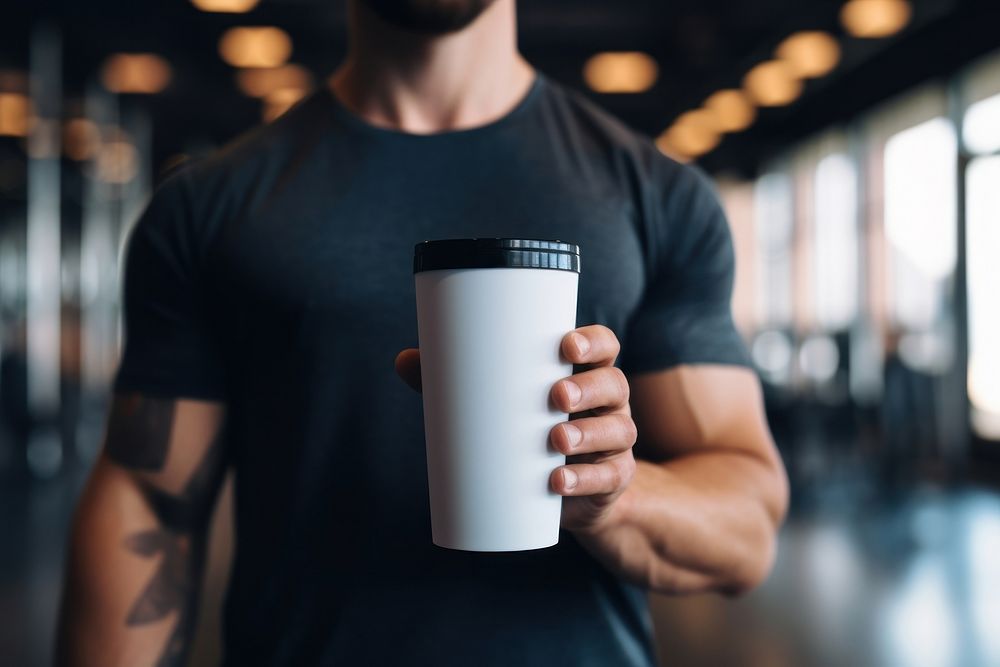 Tumbler cup holding coffee.