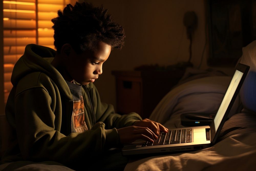 African kid computer reading bedroom.