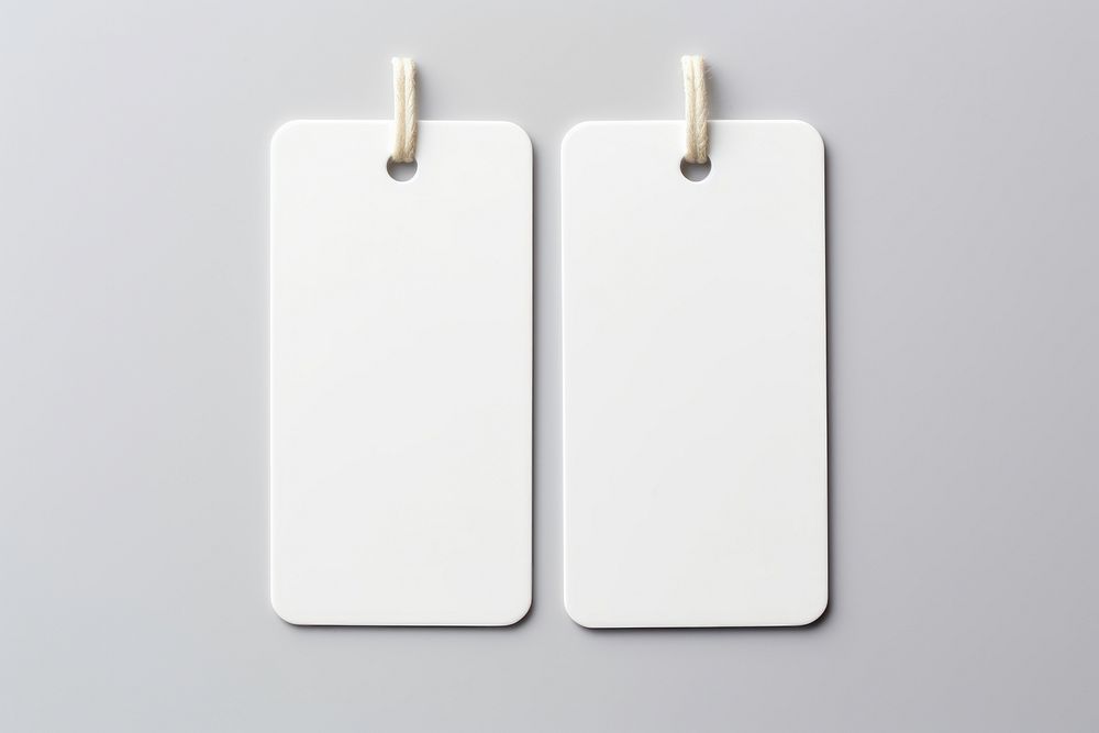 2 keys with white label plastic tag white background electronics hardware.