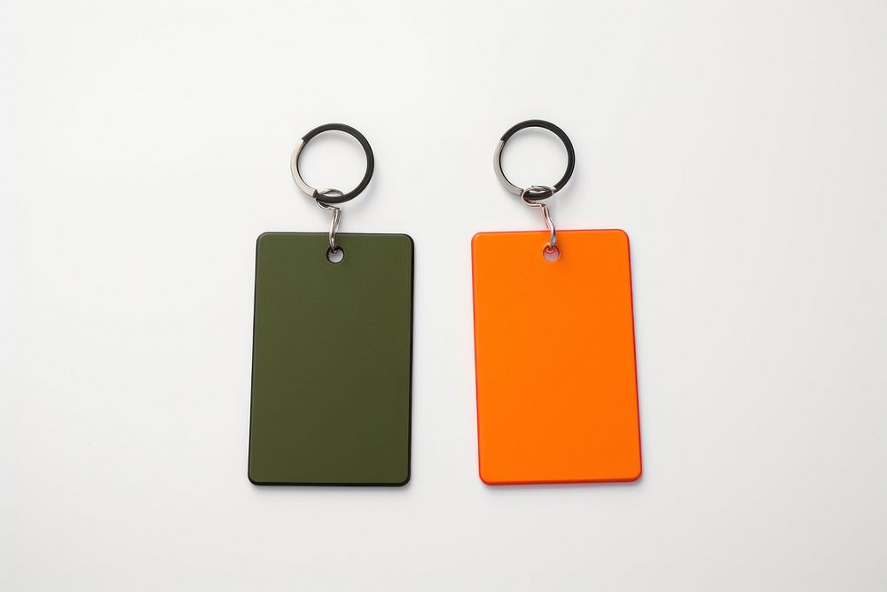 A couple of keychains with white label plastic tag white background accessories electronics.