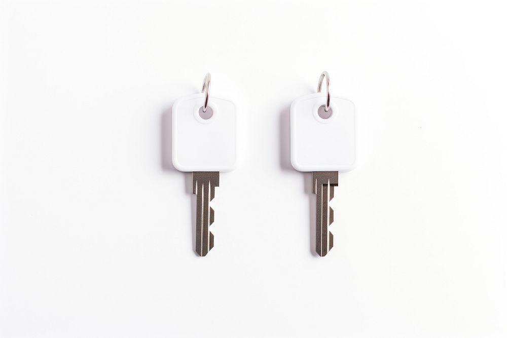 A couple of keys with white label plastic tag white background keychain security.