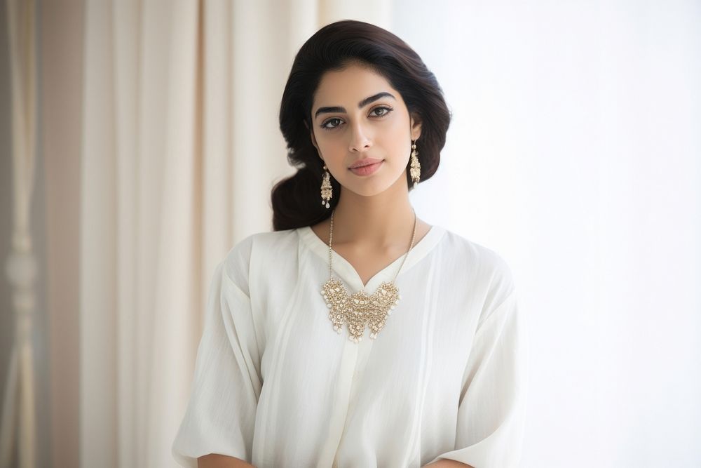 Young Qatari woman model with kundan jewelry necklace blouse white.