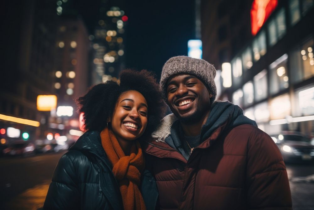 African couple smiling night city laughing.