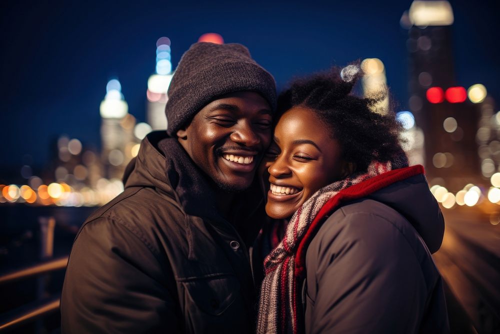 African couple smiling night city outdoors.