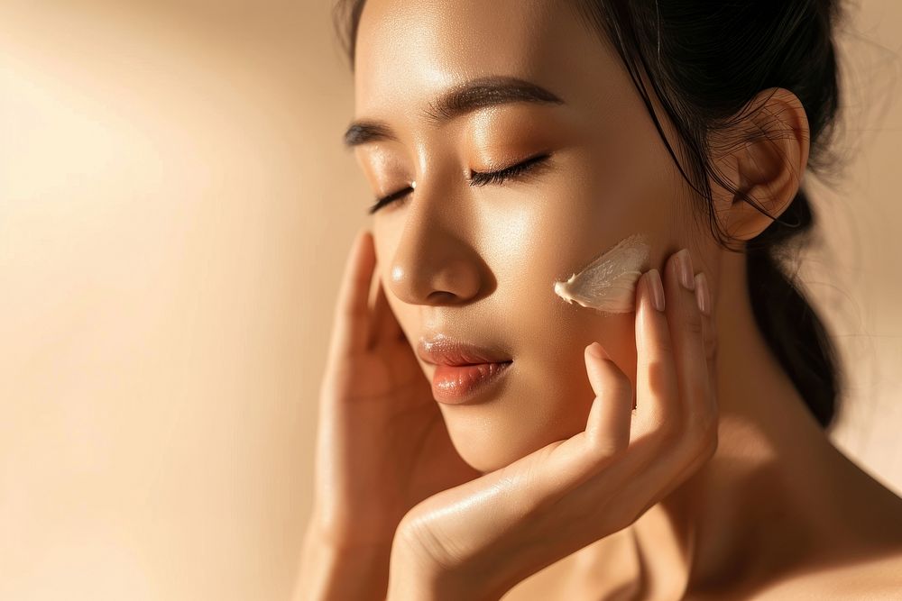 Vietnamese woman with a healthy glowing skin cosmetics portrait applying.