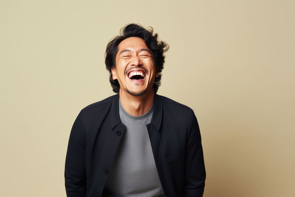 Asian man laughing adult studio shot.