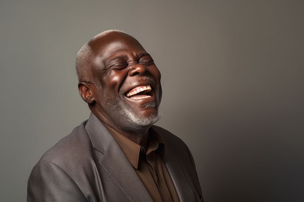 Black senior man laughing adult studio shot.