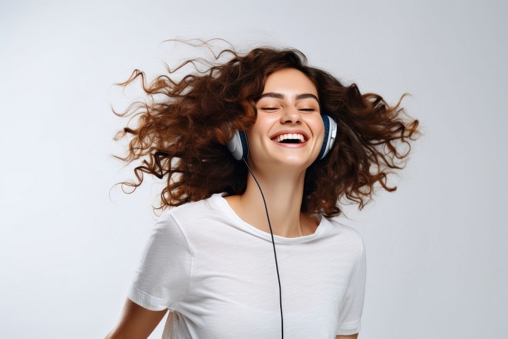 Brunette young woman dancing happy and cheerful listening laughing shouting.