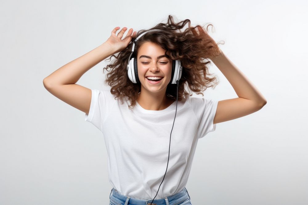 Brunette young woman dancing happy and cheerful headphones listening laughing.