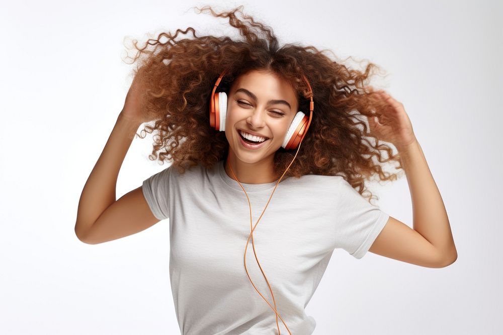 Brunette young woman dancing happy and cheerful headphones listening headset.