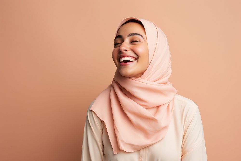 Middle eastern woman in summer outfit laughing smiling scarf.
