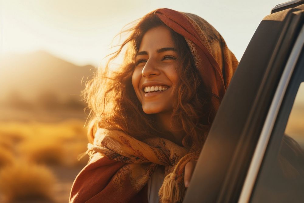 Middle eastern woman on a road trip laughing smiling summer.
