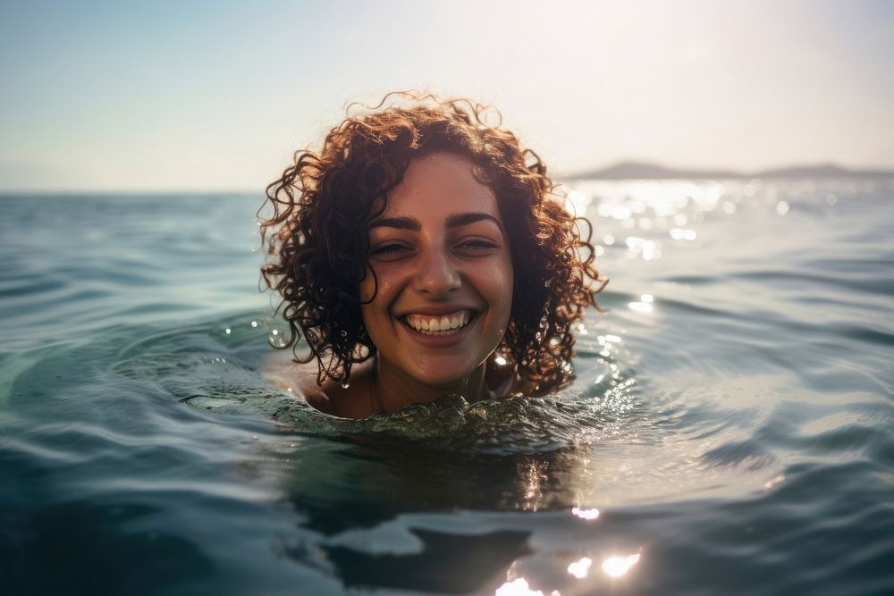 Middle eastern woman swimming outdoors smiling summer.