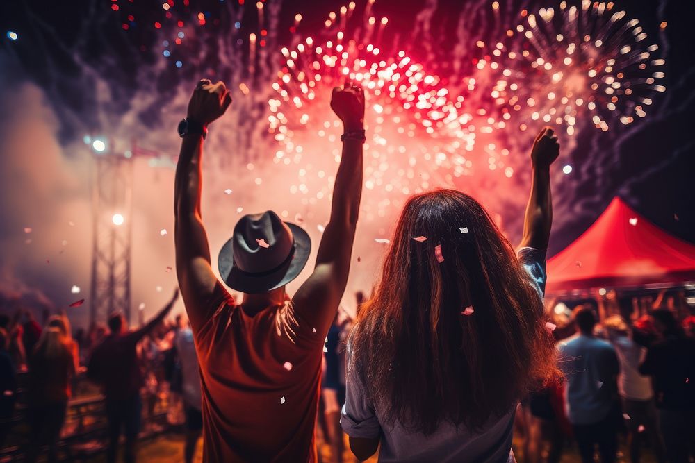 Excited people with arms raised fun nightlife fireworks.