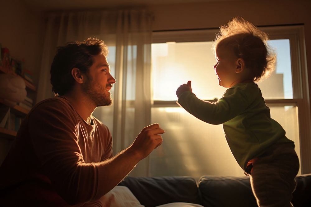 Young dad playing with his baby adult light togetherness.