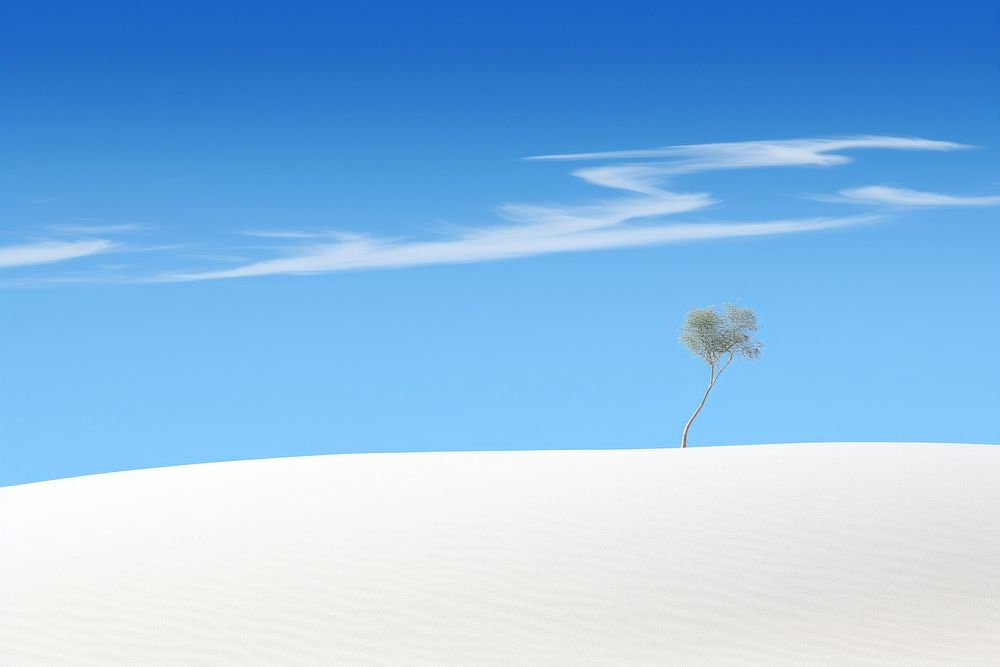  A white sand dune with a small tree sky outdoors nature. AI generated Image by rawpixel.