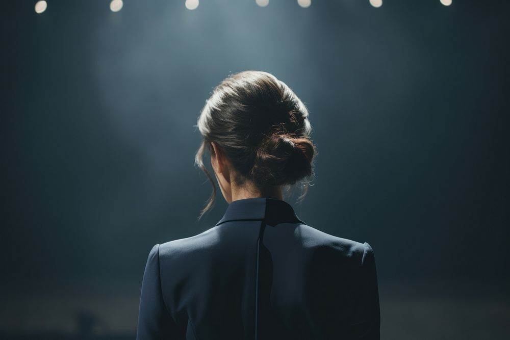 A woman in formal outfit talking in the stage light adult photo. AI generated Image by rawpixel.