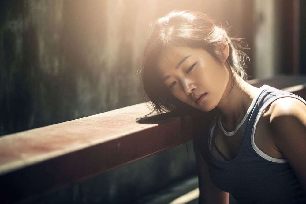 Exhausted young Asian sports woman portrait worried photo.
