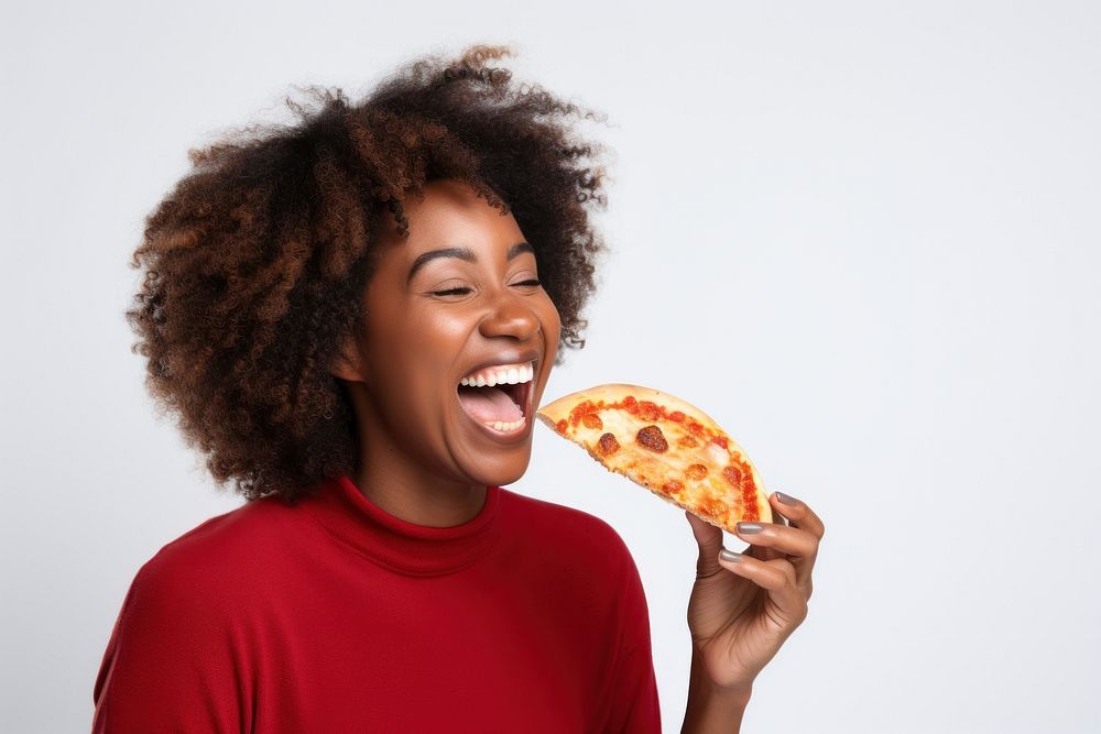 Happy African female with slice of pizza biting adult happy.