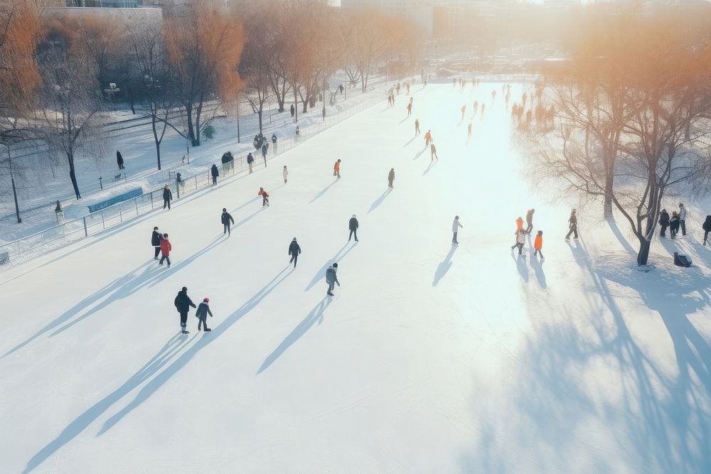 Many people are skating on a white outdoor ice rink in the city outdoors winter nature.
