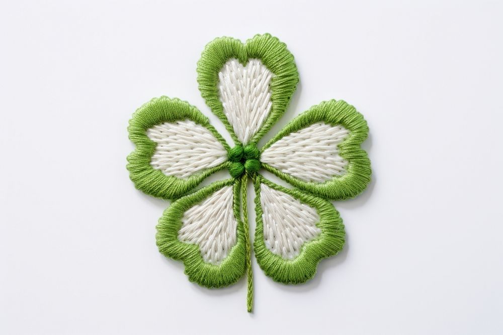 Clover in embroidery style textile pattern accessories.