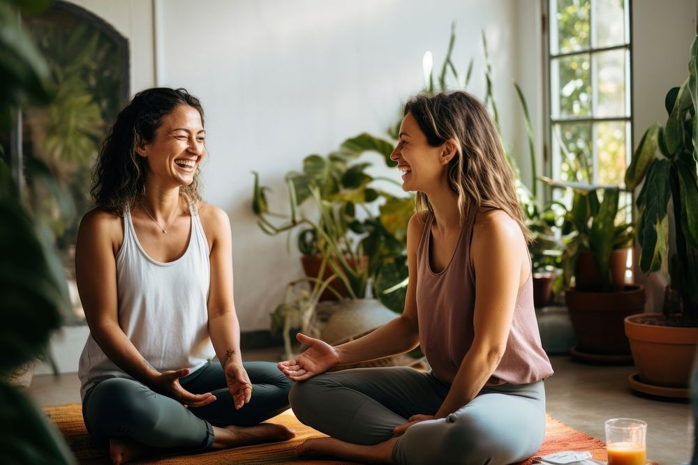Two women sitting in a yoga mat talking sports adult. AI generated Image by rawpixel.