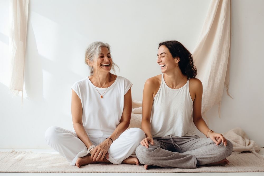 Two women sitting in a yoga mat laughing adult joy. AI generated Image by rawpixel.
