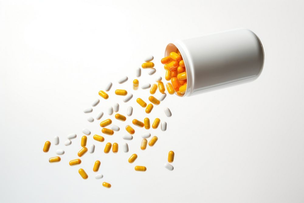 Capsules spilling out of bottle white background medication medicine. AI generated Image by rawpixel.