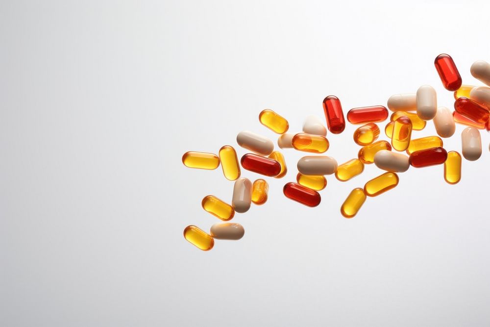 Capsules spilling out of bottle white background medication variation. AI generated Image by rawpixel.