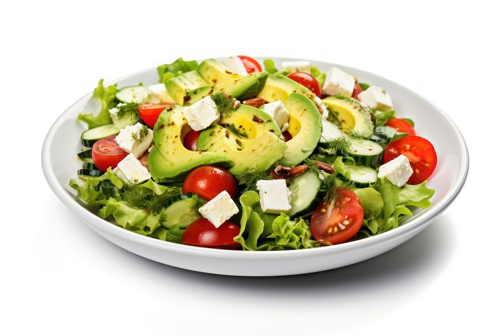 Healthy green salad with avocado feta cheese and fresh vegetables plate plant food.