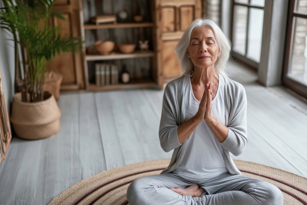 A senior woman in a yoga class meditating adult contemplation spirituality. AI generated Image by rawpixel.