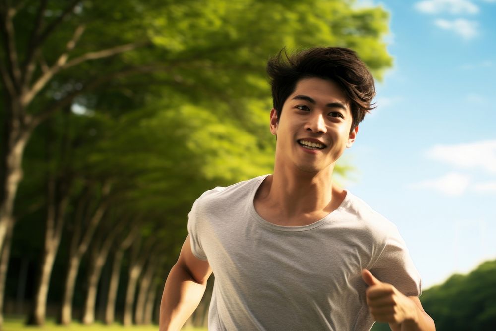 Young asian man running day sky exercising. AI generated Image by rawpixel.