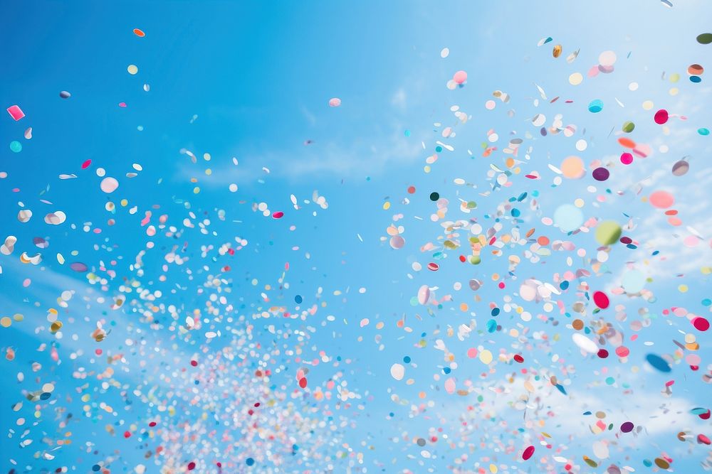 Confetti floating in the blue sky outdoors balloon nature. AI generated Image by rawpixel.