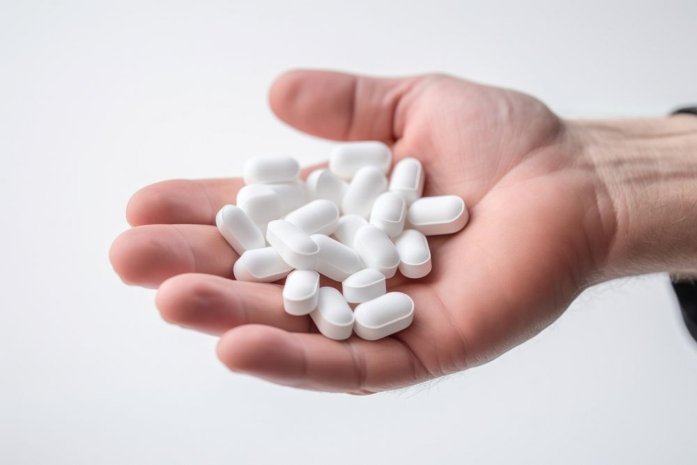 Hand holding pills white medication medicine. AI generated Image by rawpixel.