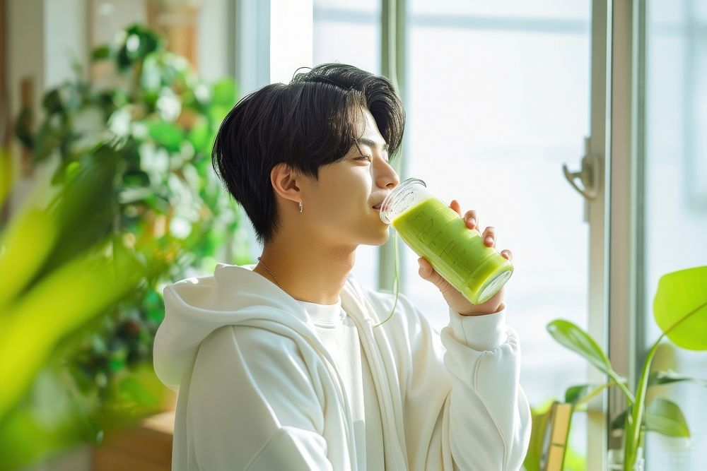 Native asian man drinking green smoothie person day contemplation. AI generated Image by rawpixel.