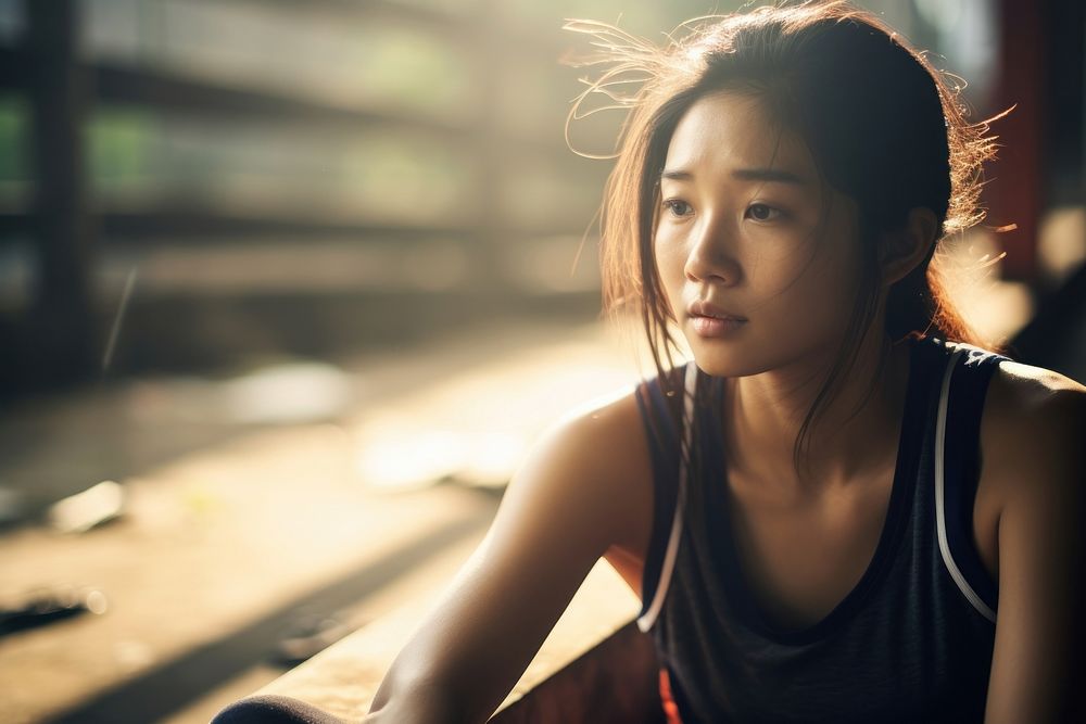 Exhausted young Asian sports woman portrait photo contemplation.