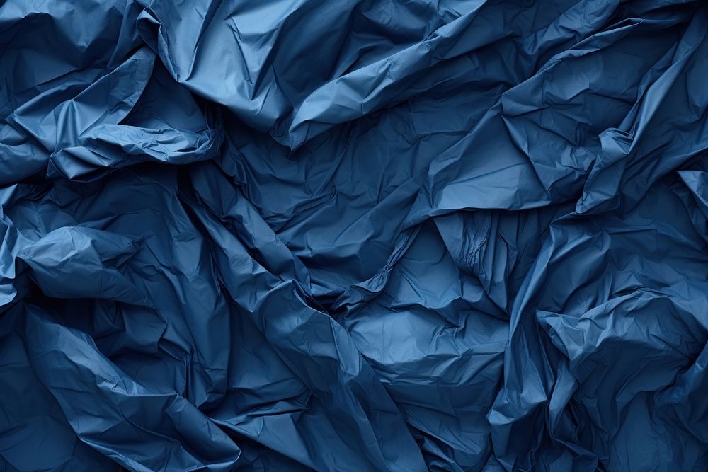 Crumpled Blue paper blue backgrounds.