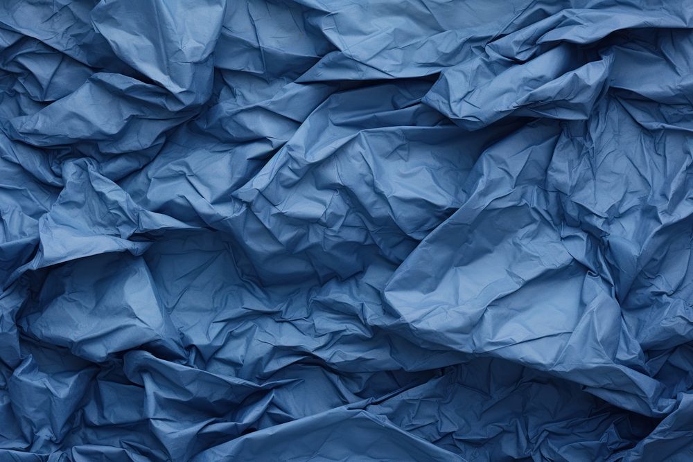 Crumpled Blue paper blue backgrounds.