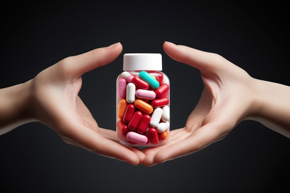 A hand holding a medicine bottle filled with colorful medicine capsules pill antioxidant medication. AI generated Image by…