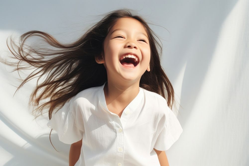 Filipino child laughing white happy.