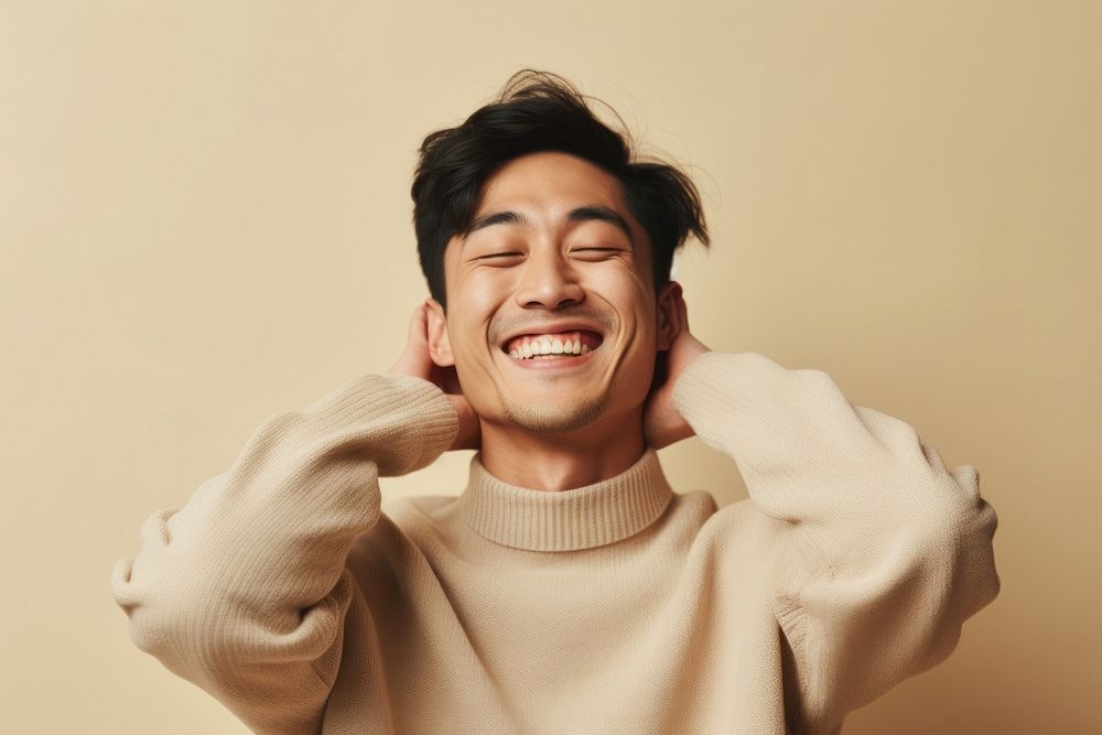 Asian man in sweater smiling laughing smile adult.