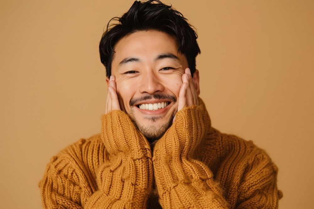 Asian man in sweater smiling laughing smile happy.