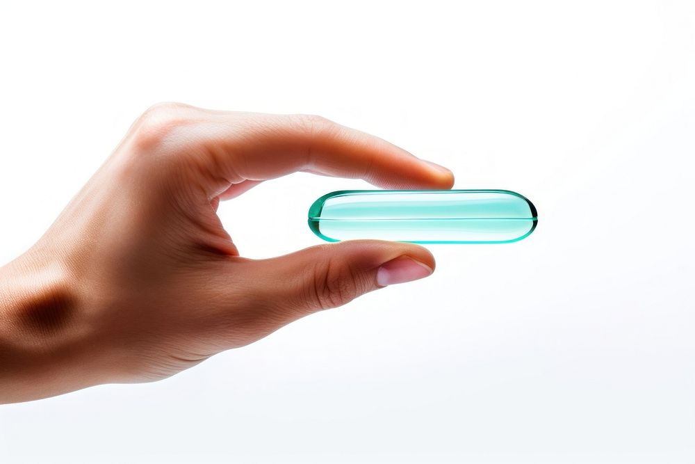 Two fingers holding a clear gel capsule medicine adult pill. AI generated Image by rawpixel.