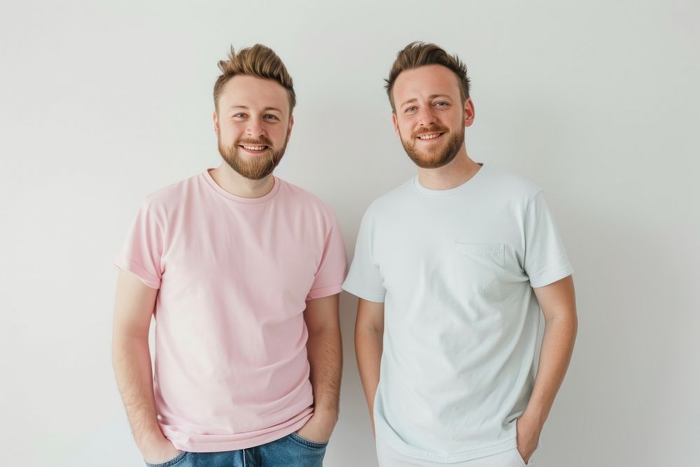 Two men standing t-shirt sleeve smile.