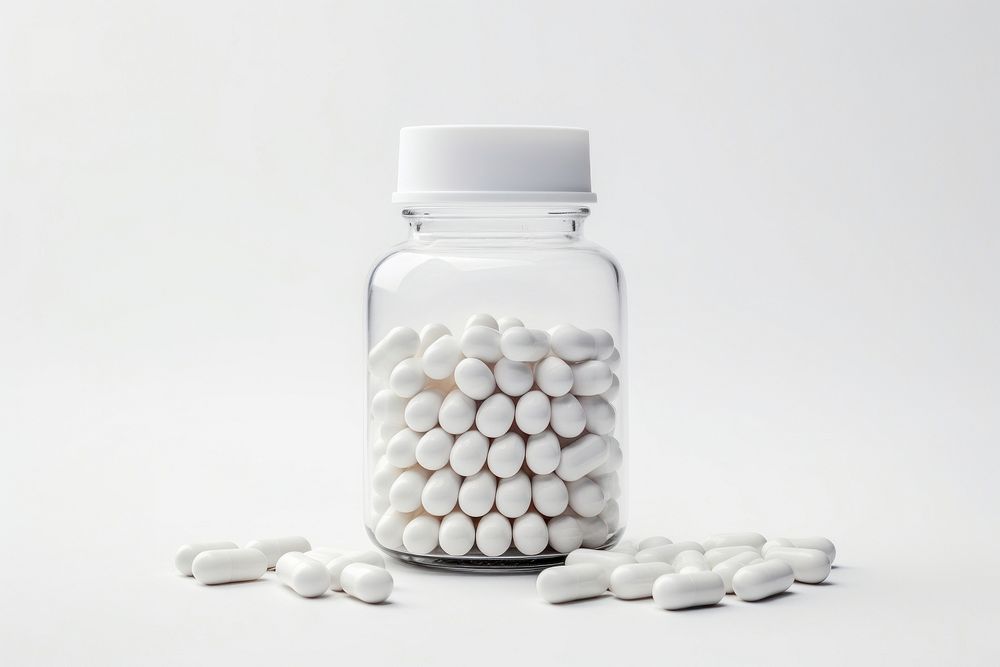 A medicine bottle filled with white medicine capsules pill white background medication. AI generated Image by rawpixel.