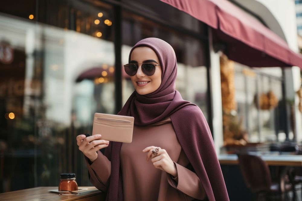 Holding hijab architecture credit card.